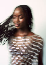 Model dancing in silver dress 