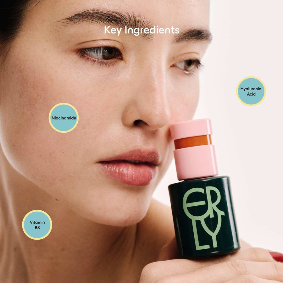 Model holding ERLY Daily Soothe green cosmetic bottle with copy about the ingredients