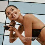 Model washing hair in black bikini with copy about Hyaluronic Acid for ERLY
