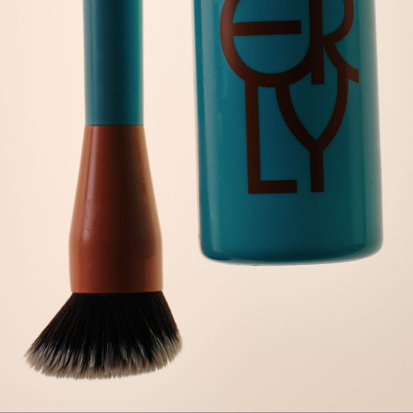 Face Foam cleanser and The Mixer brush in moody lighting. 