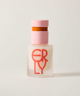 Skincare bottle with pink cap and red text on a light background