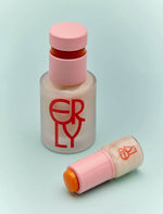 two bottles of skincare with pink top and red ERLY writing on light blue paper 