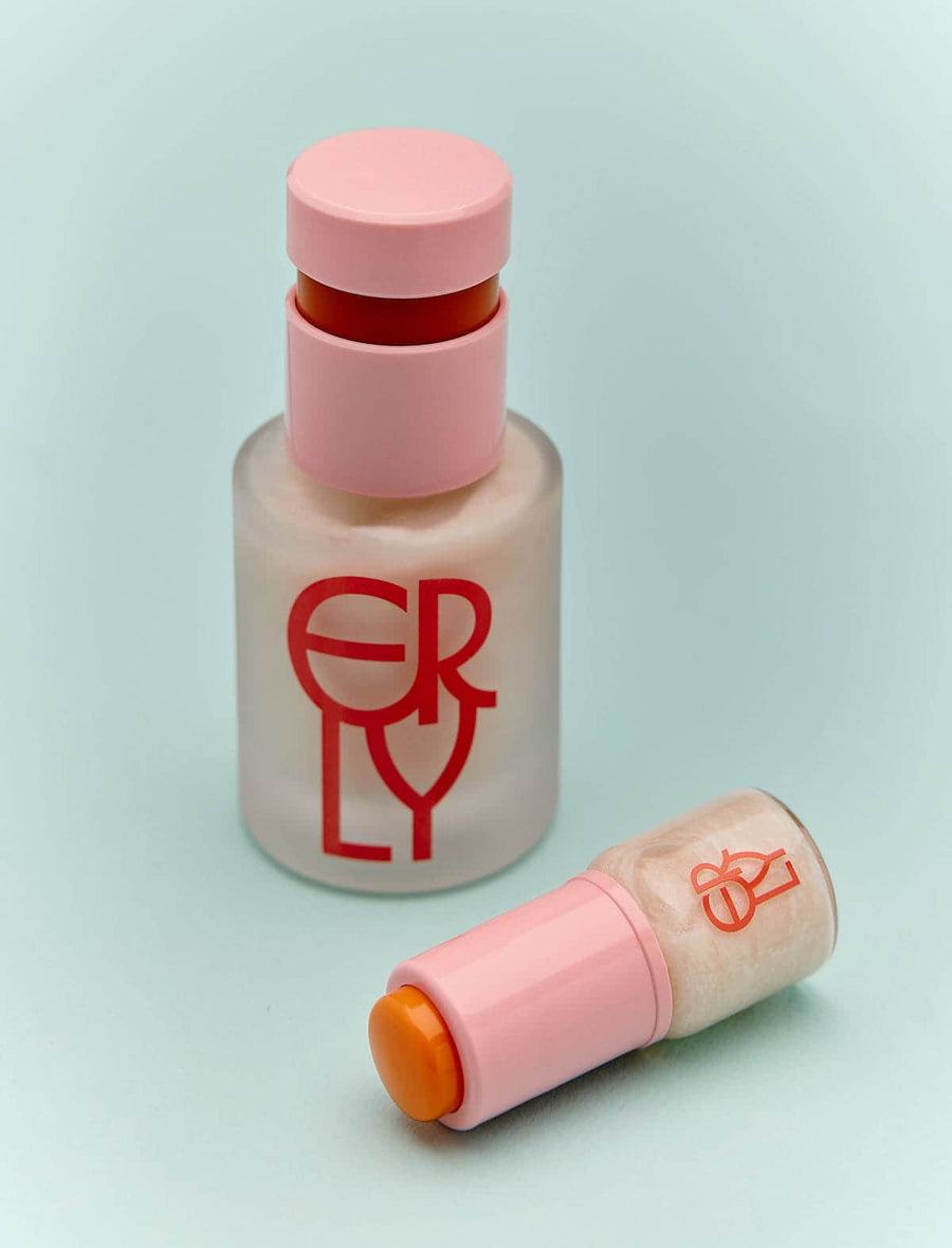 two bottles of skincare with pink top and red ERLY writing on light blue paper 