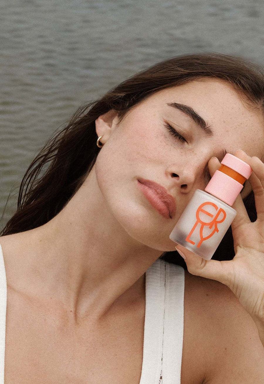 girl holding red serum in her hand new water