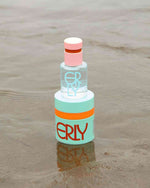 SPF moisturizer and serum skincare in the waves on a beach