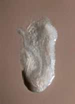 ERLY pearlescent serum swatch on light brown paper 