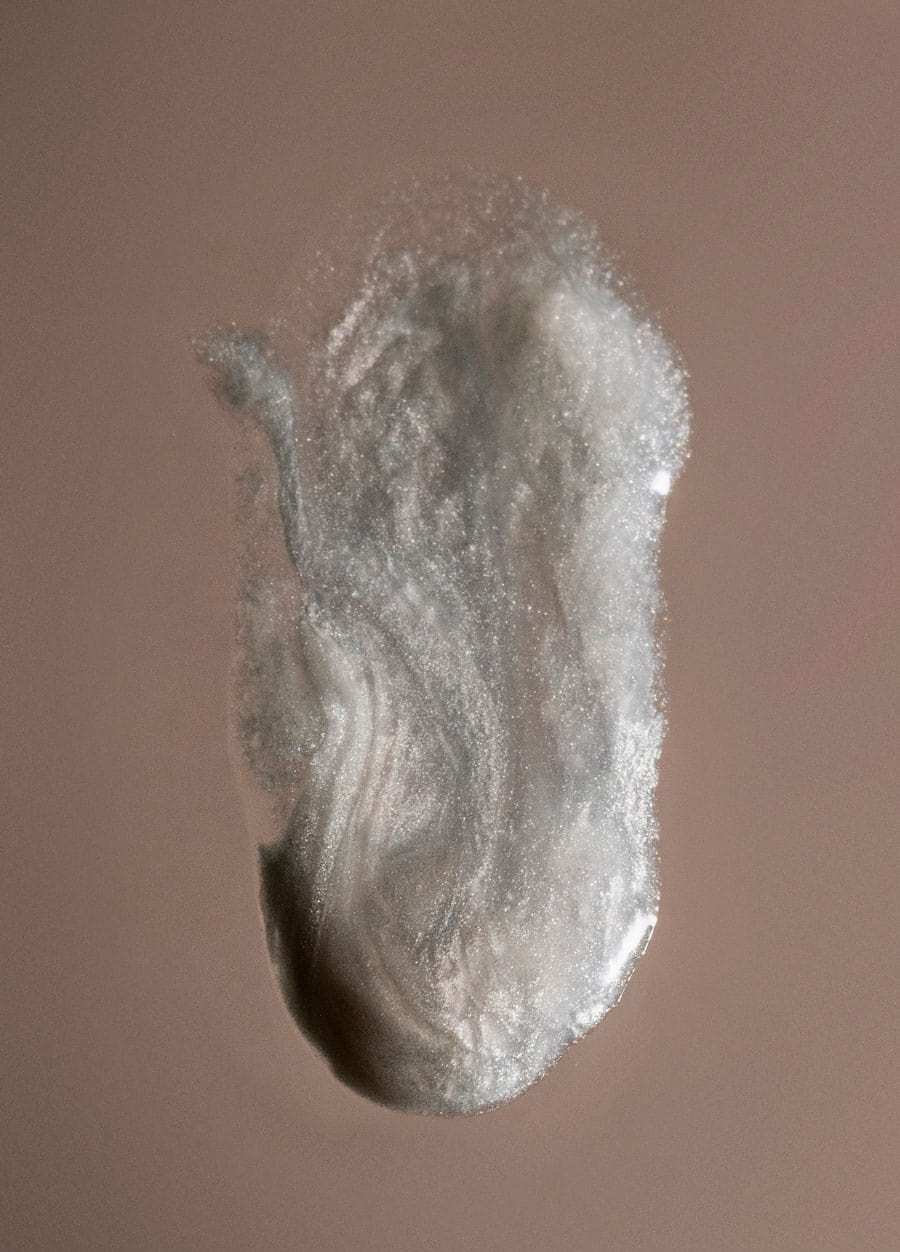 ERLY pearlescent serum swatch on light brown paper 