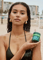 model with moisturizing cream at the beach