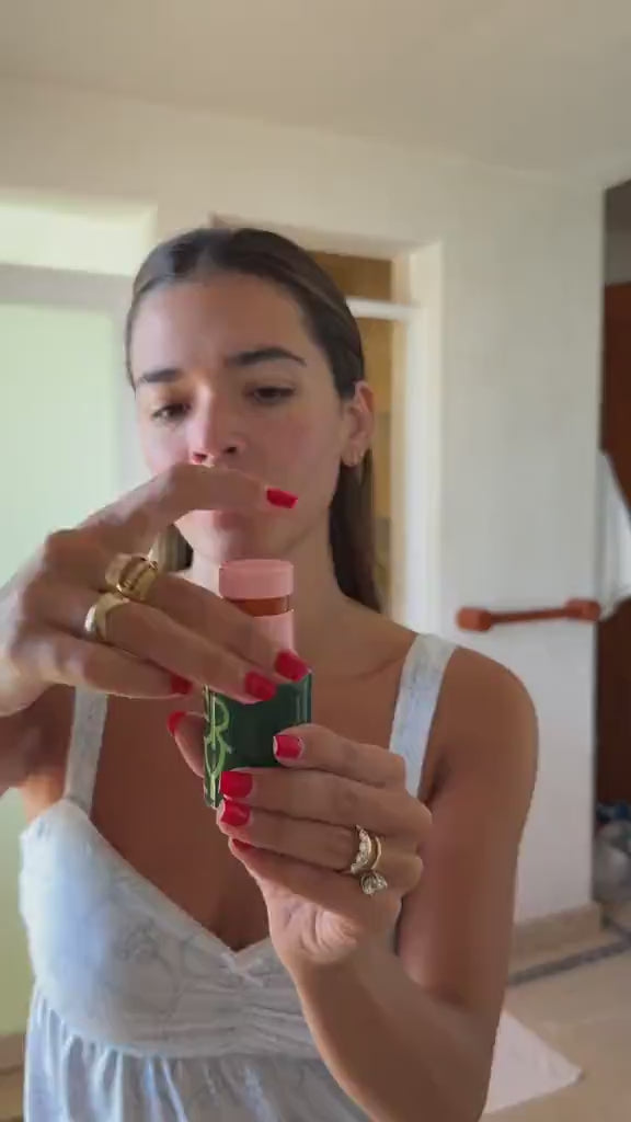 Woman applying ERLY Daily Soothe Calming Serum to her face