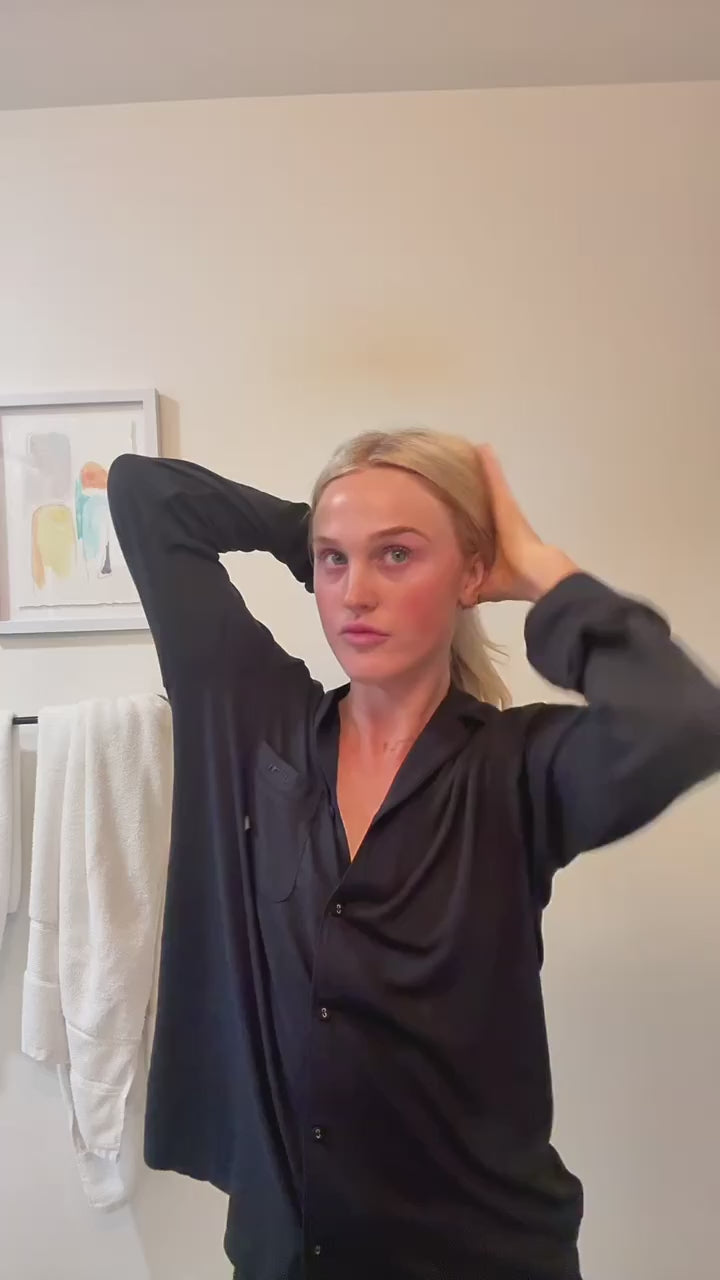 Video of woman in black pajamas using ERLY Face Foam to cleanse her face