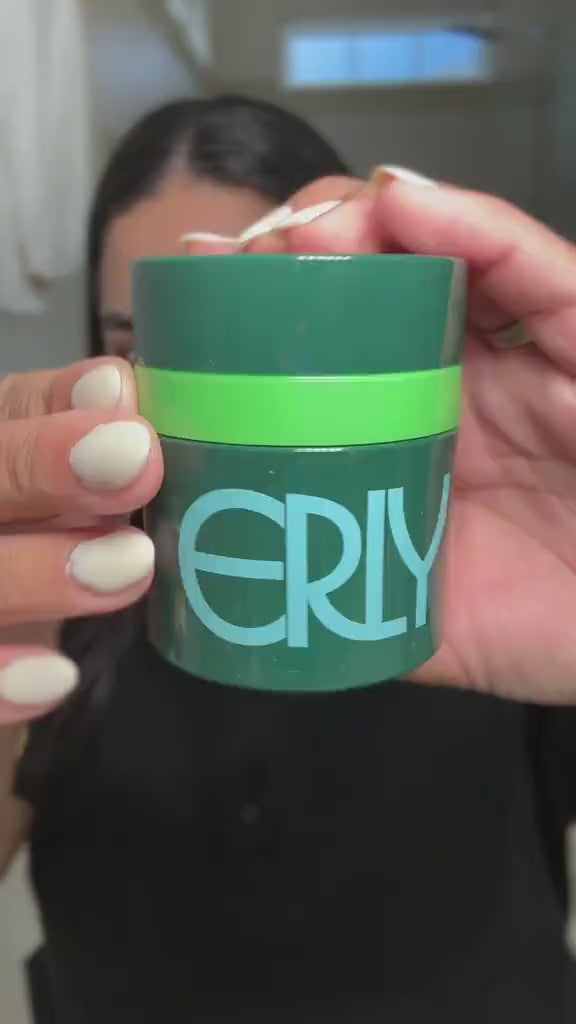 Woman showing and applying ERLY Night Moisturizer with Peptides