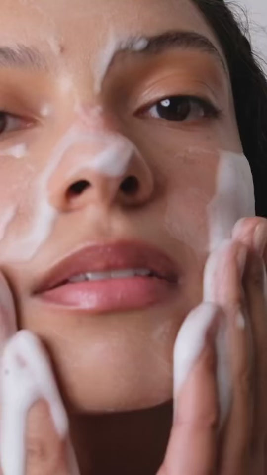 woman using face wash and serums on skin