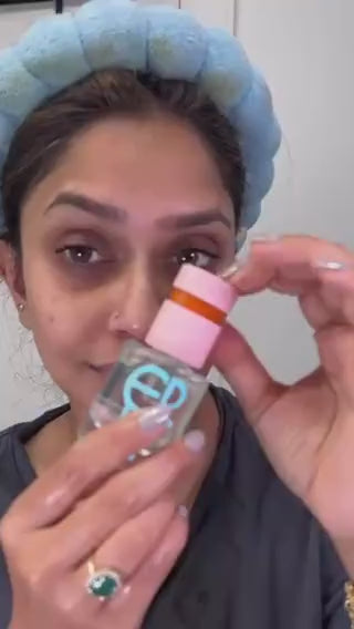 Video of a woman in a blue headband applying ERLY Splash to her face