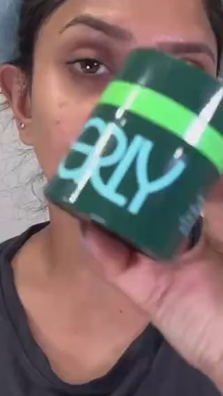 Video of a woman in a blue headband applying ERLY Night Moisturizer to her face
