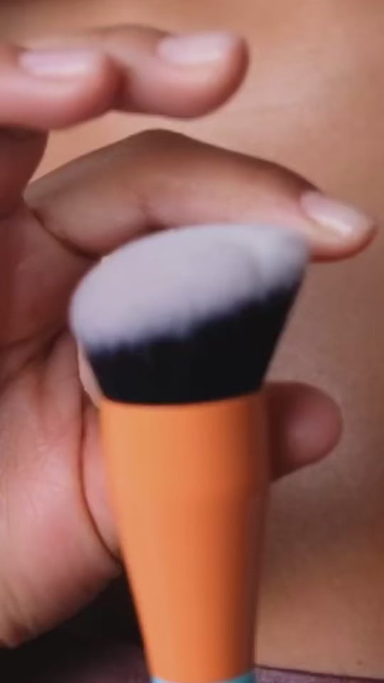 woman showing and using the brush tool for skincare