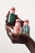 All three serums bottles being held in hands