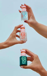 three serums being held against the sky 
