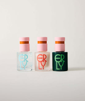 Three serum bottles with pink caps and colored bases on a white background